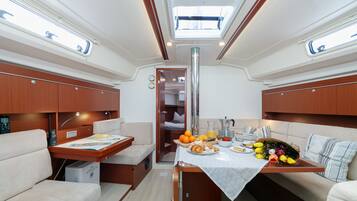 A compact interior with a dining area, a kitchenette, and a seating arrangement.