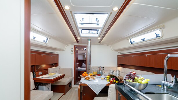 A compact galley with a sink, a small dining table, and a kitchenette.