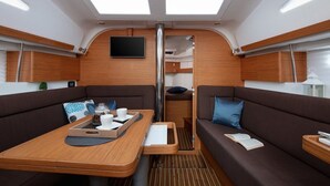 A modern interior with a central table, two sofas, a TV, and a ceiling with skylights. - Sun-Kissed Sailing Adventure in Split, Croatia (Split)