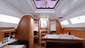 A yacht interior with a control panel, seating, a map, and a small bar area. - Sun-Kissed Sailing Adventure in Split, Croatia (Split)