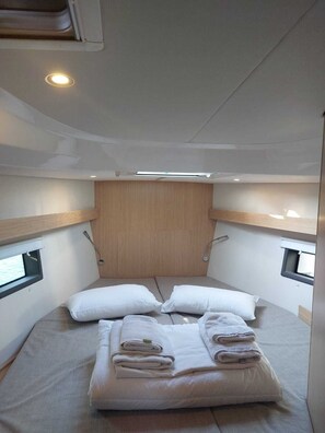 A compact, well-lit cabin with a single bed, wooden headboard, and two small windows. - Sun-Kissed Sailing Adventure in the Ionian Islands, Lefkada (Lefkada)