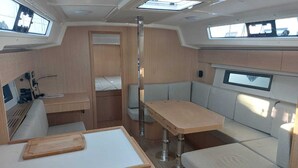 A compact interior with a dining area, seating, and a small kitchenette. - Sun-Kissed Sailing Adventure in the Ionian Islands, Lefkada (Lefkada)