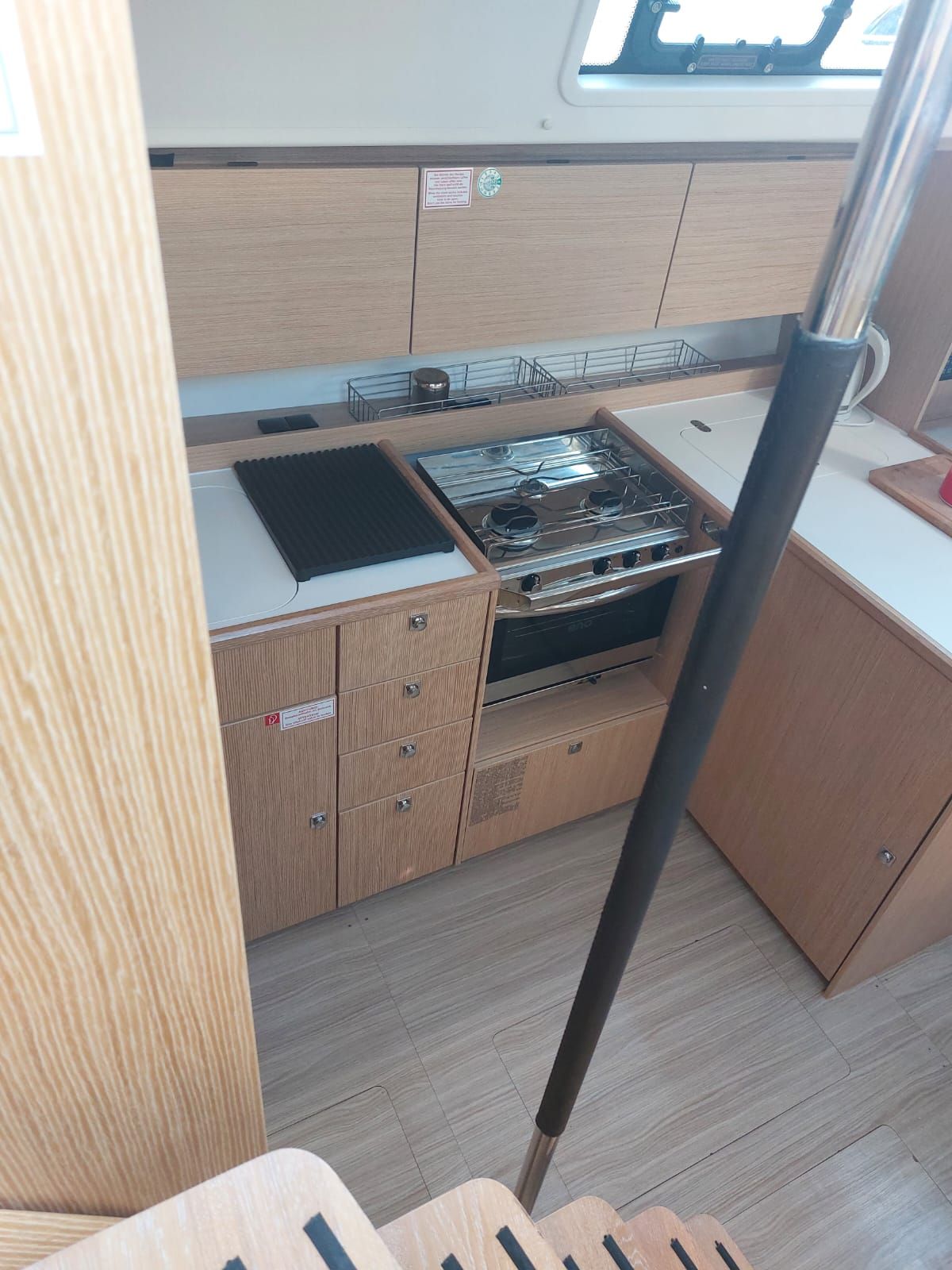 A compact kitchen with a stove, sink, and storage cabinets.