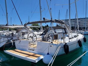 A marina with multiple sailboats docked, featuring a prominent 'Carod' name on the side of one boat. - Sun-Kissed Sailing Adventure in Istria, Croatia (Pula)