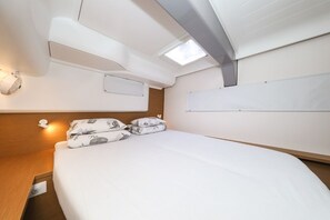 A modern, well-lit bedroom with a neatly made bed, a headboard, and a skylight. - Sibenik Sun-soaked Sailing: A Luxurious Croatian Voyage (Pirovac)