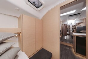 A compact RV interior with a kitchenette, a small seating area, and a window with a view. - Sun-Kissed Sailing Adventure in Zadar, Croatia (Biograd na moru)