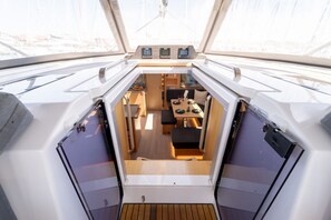 A boat's interior with a dining area, control panels, and a view through the windows. - Sibenik Sun-soaked Sailing: A Luxurious Croatian Voyage (Pirovac)