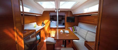 A compact interior with a kitchenette, dining area, and seating.