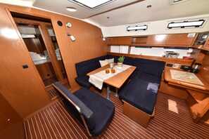 A compact galley with a dining table, seating, and a small kitchenette. - Sun-Kissed Sailing Adventure in Zadar, Croatia (Bibinje)