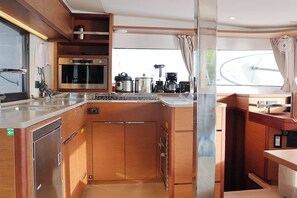 A compact kitchen with a microwave, oven, and coffee maker.
