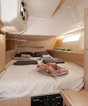 A compact RV interior with a bed, a control panel, and a skylight. - Sun-Kissed Sailing Adventure in the Ionian Islands, Lefkada (Lefkada)