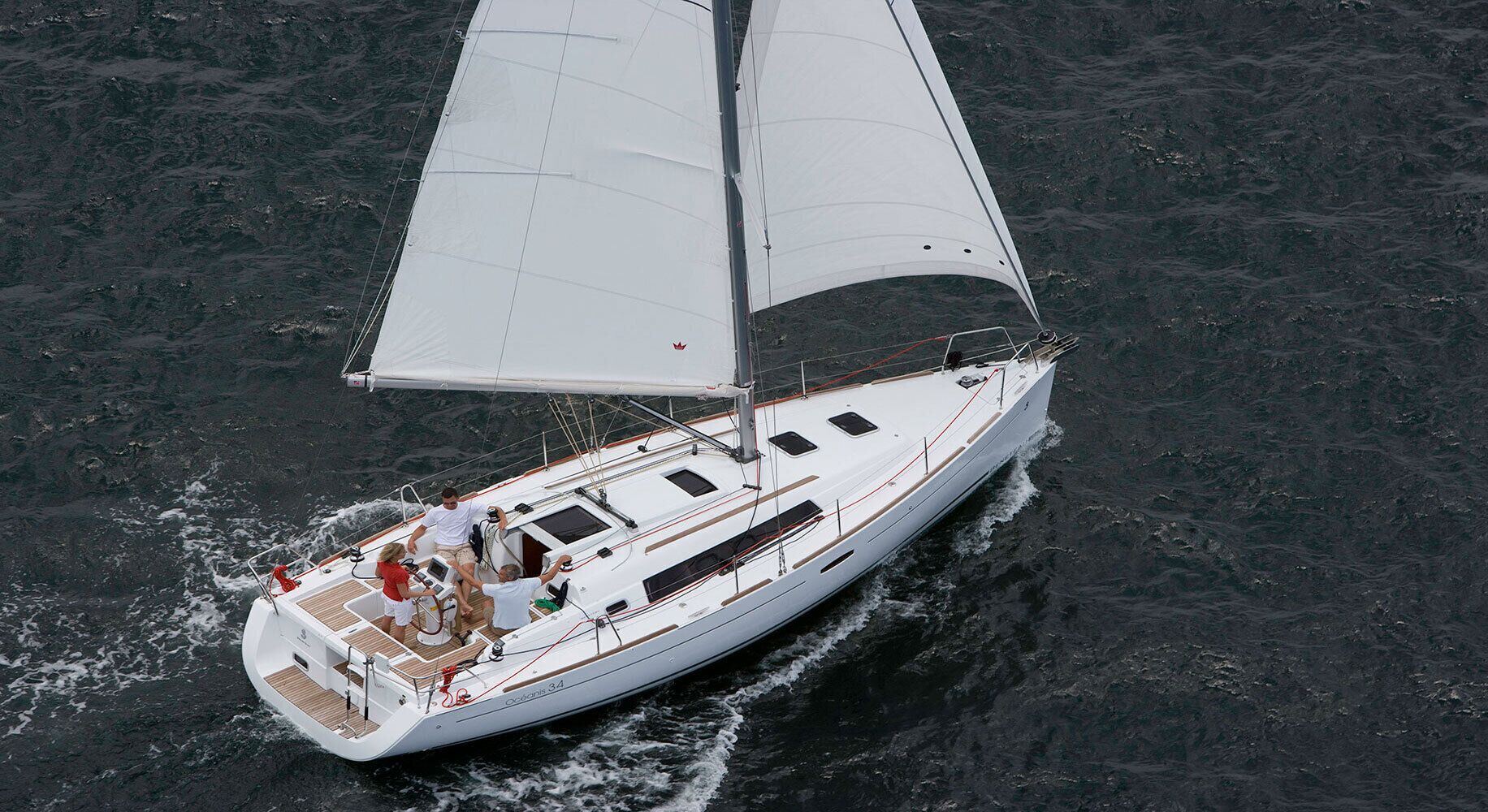 A sailboat with a deck area, a cabin, and a mast.