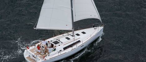 A sailboat with a deck area, a cabin, and a mast.
