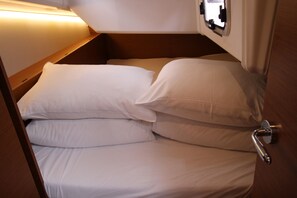 A bunk bed with white bedding, a wooden headboard, and a metal door handle. - Sun-Kissed Sailing Adventure in Zadar, Croatia (Biograd na moru)