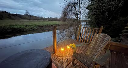 A beautifully styled duplex apartment with private riverside decking& a fire pit