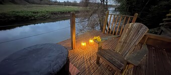 A beautifully styled duplex apartment with private riverside decking& a fire pit