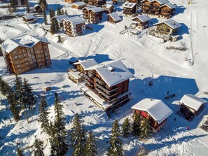 A snow-covered ski resort with multiple wooden lodges, ski trails, and pine trees. - Bürcher Haus 1. OG Süd-West Appartement/Fewo, Dusche, WC by Interhome (Riederalp)