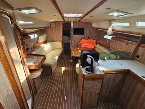 A compact RV interior with a kitchenette, seating area, and a small bathroom. - Sun-Kissed Sailing Adventure in Zadar, Croatia (Biograd na moru)