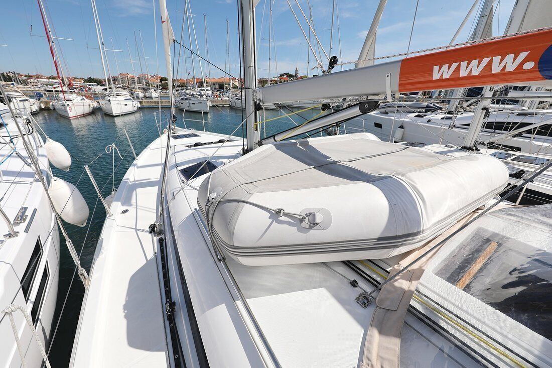 A marina with multiple sailboats docked.
