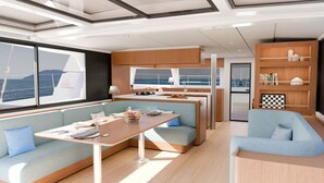 A modern interior with a dining area, seating, and a view of the sea. - Sun-Kissed Sailing Adventure in Islas Sarónicas (Alimos)