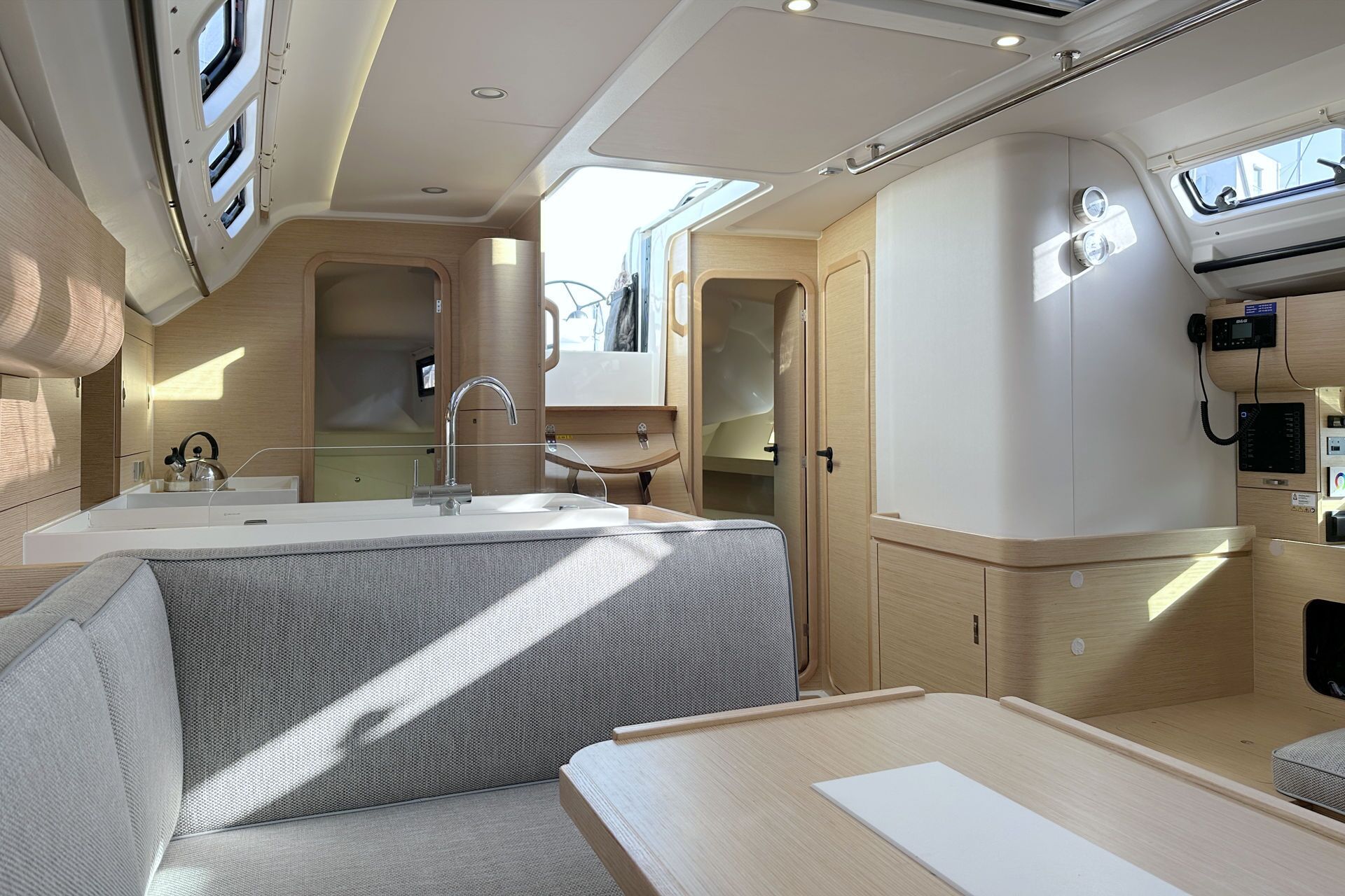 A compact, well-lit interior with a kitchenette, a seating area, and a small table.