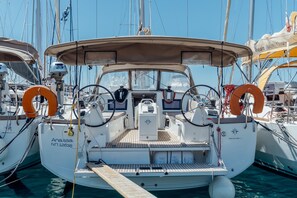 A boat with a covered deck, life rings, and a steering wheel. - Sun-Kissed Sailing Adventure in the Dodecanese Islands (Kos)