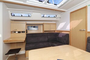 A compact RV interior with a kitchenette, a cushioned seating area, and skylights. - Sun-Kissed Sailing Adventure in Zadar, Croatia (Biograd na moru)