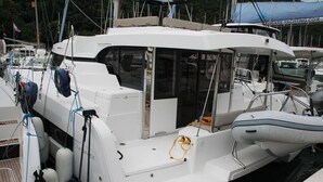 A white boat with a cabin, a small outboard motor, and a covered area at the stern. - Dubrovnik Delight: A Sun-Kissed Sailing Experience (Komolac)