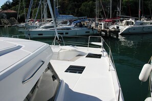 A marina with multiple sailboats docked. - Dubrovnik Delight: A Sun-Kissed Sailing Experience (Komolac)