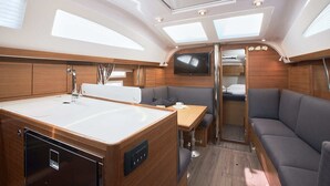 A compact galley with a sink, a small table, and seating. - Sun-Kissed Sailing Adventure in Split, Croatia (Kaštel Gomilica)