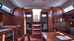 A compact, well-lit interior with a kitchenette, a small seating area, and a narrow passage leading to a sleeping area. - Sun-Kissed Sailing Adventure in Zadar, Croatia (Biograd na moru)