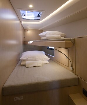 A bunk bed with a skylight above, a bedside table, and a wall-mounted TV. - Sun-Kissed Sailing Adventure in Split, Croatia (Kaštel Gomilica)