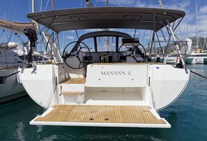A yacht named 'MANANN II' with a wooden deck, a steering wheel, and a canopy. - Sun-Kissed Sailing Adventure in Split, Croatia (Kaštel Gomilica)