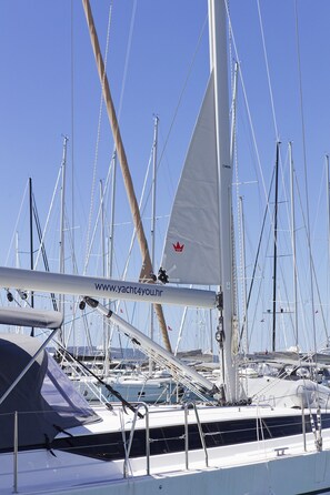 A marina with multiple sailboats docked, featuring masts and rigging. - Sun-Kissed Sailing Adventure in Split, Croatia (Kaštel Gomilica)