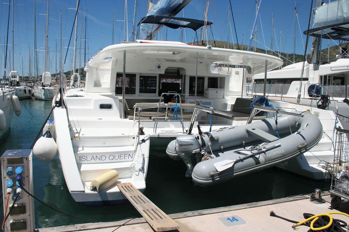 A marina with boats docked, including one named 'ISLAND QUEEN'.