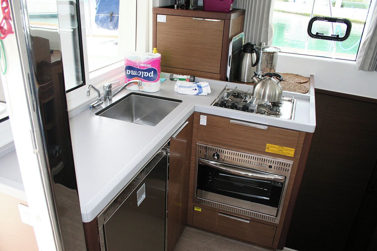 A compact kitchenette with a sink, stove, and oven.