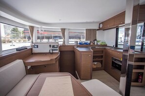 A compact kitchen with a stove, oven, and a small countertop. - Sun-kissed Sailing Adventure in Split-Dalmatia, Croatia (Seget Donji)