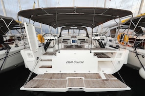 A boat named 'Chill Course' with a covered deck, steering wheel, and control panel. - Sun-Kissed Sailing Adventure in Zadar, Croatia (Biograd na moru)
