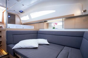 Um interior moderno com sofá, uma mesa pequena e janela com vista.