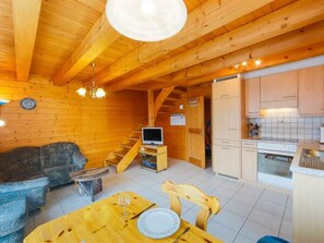 A wooden interior with a sofa, dining table, and kitchen area. - Stubulti Appartement/Fewo, Dusche und Bad, WC 3 1/2 Zimmerwohnung, 4-Betten by Interhome (Riederalp)