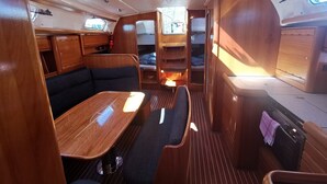 A compact RV interior with a dining area, seating, and a small kitchenette. - Sun-Kissed Sailing Adventure in Sibenik, Croatia (Primošten)