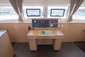 A cabin with a desk, two monitors, and a view of the sea. - Sun-Kissed Sailing Adventure in Islas Baleares, Mallorca (Palma)
