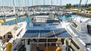 A yacht named 'Time Out' with a covered deck area, solar panels, and seating. - Sun-Kissed Sailing Adventure in Zadar, Croatia (Bibinje)