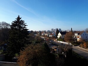 A residential area with houses, a road, and a clear sky.