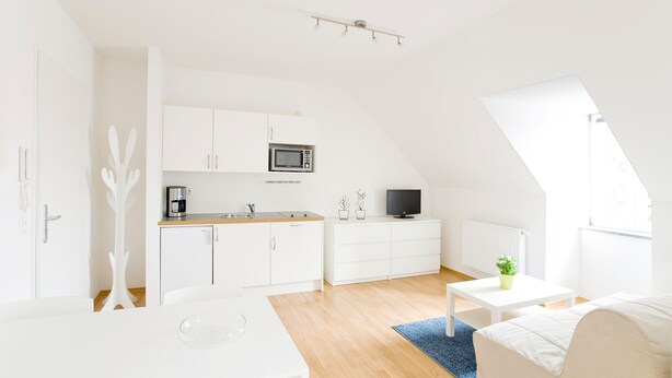 A modern, white interior with a kitchen, dining area, and living space. - City, Country, River Studio Apartment '3' (Regensburg)