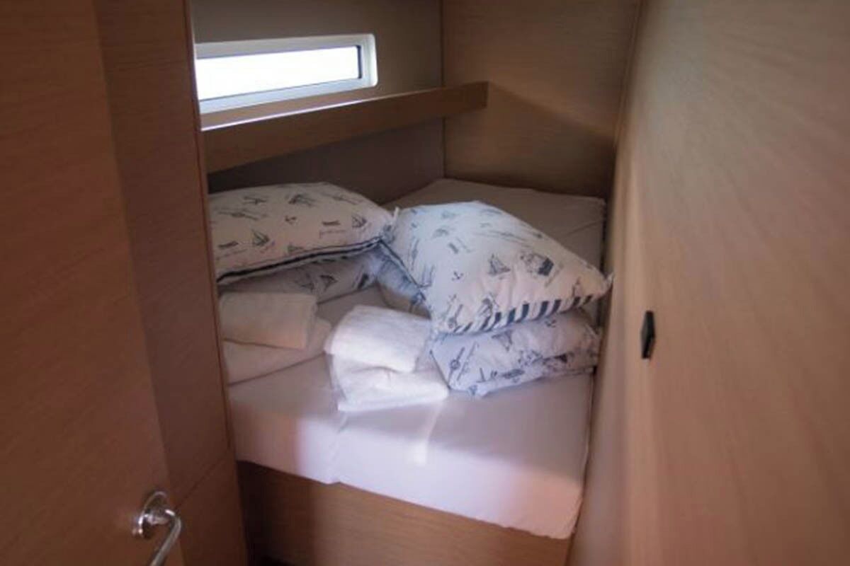 A small, enclosed sleeping area with a bunk bed, a window, and a door.