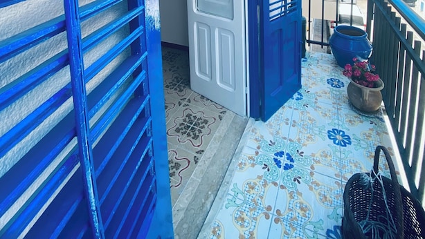 A balcony with a tiled floor, a white door, and blue shutters. - Blue Dream Balestrate (Balestrate)