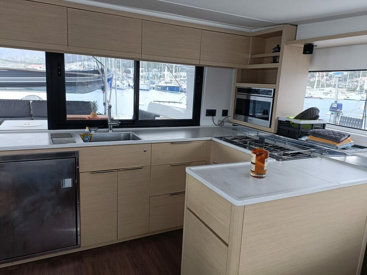 Una cocina moderna con un ventanal grande, electrodomésticos de acero inoxidable y armarios de madera.