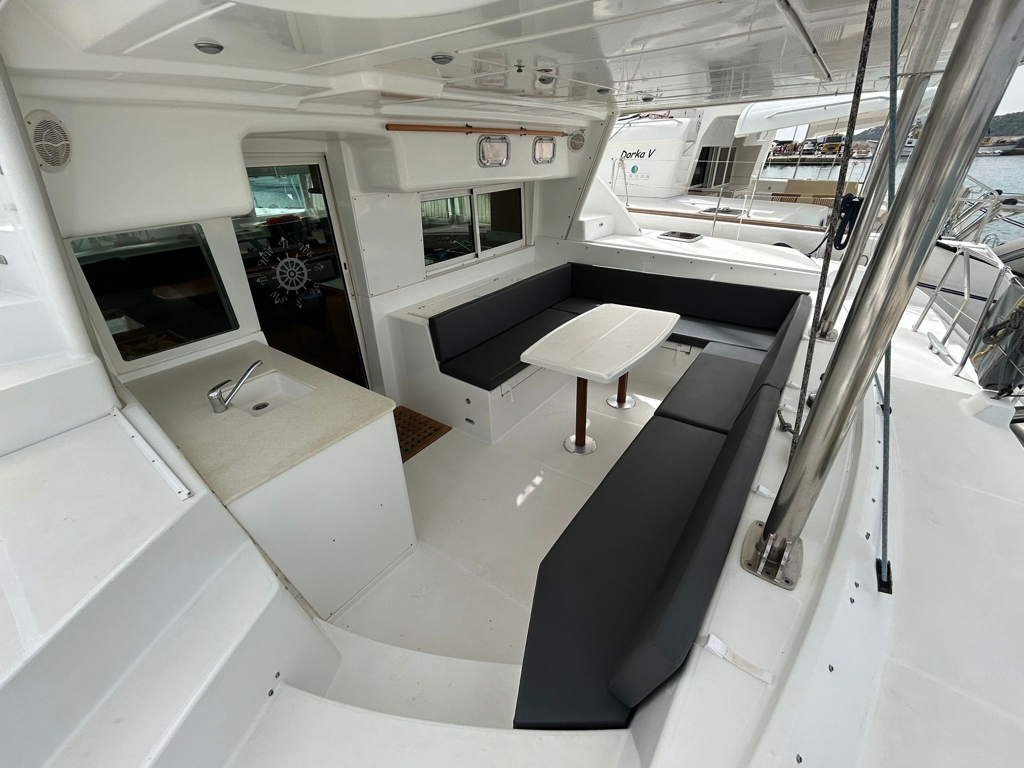A compact galley with a sink, a small table, and a seating area.