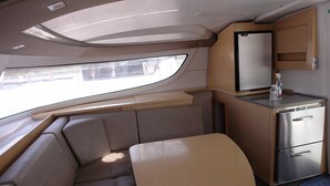 A compact kitchenette with a refrigerator, a small countertop, and a window. - Sun-Kissed Sailing Adventure in Northern Croatia (Punat)